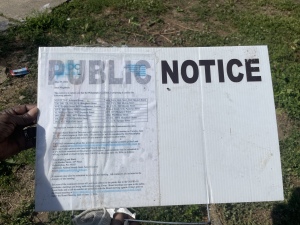 Trina holding the public notice sign. (GIH | Dashiell Allen)